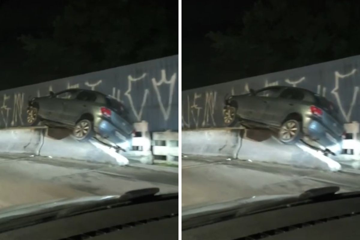 Carro colide e fica suspenso em mureta de ponte na rodovia Rio-Santos em Caraguatatuba